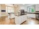 Open-concept kitchen with white cabinets, stainless steel appliances, and an island cooktop at 1900 Denton Walk Ct, Marietta, GA 30062