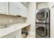 Modern laundry room featuring a stacked washer and dryer and built-in sink at 1900 Denton Walk Ct, Marietta, GA 30062