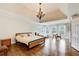 Spacious main bedroom with hardwood floors, a tray ceiling, and lots of natural light at 1900 Denton Walk Ct, Marietta, GA 30062