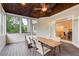 Inviting screened porch with a dining table and seating with views to the backyard at 1900 Denton Walk Ct, Marietta, GA 30062