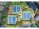 Aerial view of the community's three tennis courts surrounded by lush landscaping, pavilion, and lake at 1900 Denton Walk Ct, Marietta, GA 30062
