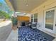 Inviting covered patio with outdoor seating, a grill and a leafy potted plant for ambiance at 5576 Rockfern Drive, Lilburn, GA 30047