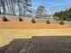 Spacious backyard with a newly mulched garden bed along the fence line, offering a tidy landscape at 5576 Rockfern Drive, Lilburn, GA 30047