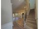 Spacious entryway with wood-look flooring leading into an open floor plan and carpeted stairs at 5576 Rockfern Drive, Lilburn, GA 30047