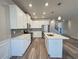 Modern kitchen featuring white cabinets, stainless steel appliances, quartz countertops, and island at 5576 Rockfern Drive, Lilburn, GA 30047