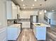 Modern kitchen featuring white cabinets, stainless steel appliances, quartz countertops, and island at 5576 Rockfern Drive, Lilburn, GA 30047