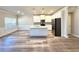 Open-concept living space featuring a modern kitchen, stainless steel appliances, and luxury vinyl flooring at 5576 Rockfern Drive, Lilburn, GA 30047