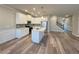 Open-concept living space featuring a modern kitchen, stainless steel appliances, and luxury vinyl flooring at 5576 Rockfern Drive, Lilburn, GA 30047