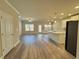 Open-concept living space featuring a modern kitchen, stainless steel appliances, and luxury vinyl flooring at 5576 Rockfern Drive, Lilburn, GA 30047