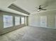 Spacious main bedroom featuring a tray ceiling, ceiling fan, and neutral paint at 5576 Rockfern Drive, Lilburn, GA 30047