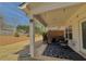 Cozy covered patio with string lights, stylish outdoor seating, and a view of the well-maintained backyard at 5576 Rockfern Drive, Lilburn, GA 30047