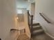 Carpeted staircase with light wood handrails, decorative black metal spindles, and neutral paint at 5576 Rockfern Drive, Lilburn, GA 30047