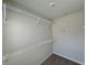 Walk-in closet features multiple shelves for organization at 5576 Rockfern Drive, Lilburn, GA 30047