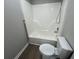 Bathroom featuring a shower-tub combo, toilet, and gray walls at 5961 Sherwood Trce, Stonecrest, GA 30038
