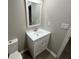 Bathroom vanity with a white sink, white cabinets and a mirror at 5961 Sherwood Trce, Stonecrest, GA 30038