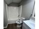 Bathroom featuring a shower-tub combo, toilet, and gray walls at 5961 Sherwood Trce, Stonecrest, GA 30038