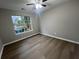 Bright bedroom features hardwood floors and a window overlooking a garden view at 5961 Sherwood Trce, Stonecrest, GA 30038