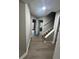 Hallway with hardwood floors leading to staircase and doorway at 5961 Sherwood Trce, Stonecrest, GA 30038