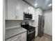 Updated kitchen featuring granite countertops and stainless steel appliances at 5961 Sherwood Trce, Stonecrest, GA 30038