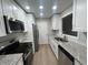 Bright kitchen boasts white cabinets, granite countertops, stainless appliances and a large window at 5961 Sherwood Trce, Stonecrest, GA 30038