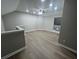 Loft featuring wood-look floors and modern ceiling fan at 5961 Sherwood Trce, Stonecrest, GA 30038