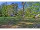 Expansive backyard featuring a shed, mature trees, and plenty of green space at 8304 Ephesus Church Rd, Villa Rica, GA 30180