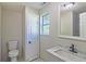 Bright bathroom with marble countertop vanity, white cabinets, and tile shower at 8304 Ephesus Church Rd, Villa Rica, GA 30180