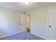 Bright bedroom featuring neutral paint, carpet, and two white doors, offering a cozy retreat at 8304 Ephesus Church Rd, Villa Rica, GA 30180