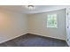 Cozy bedroom with a neutral color palette, plush carpet, and a bright window view at 8304 Ephesus Church Rd, Villa Rica, GA 30180