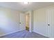Neutral bedroom featuring soft carpet, fresh paint, and ample natural light from the window at 8304 Ephesus Church Rd, Villa Rica, GA 30180
