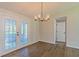 Bright dining room featuring wood floors, contemporary light fixture, and double glass doors at 8304 Ephesus Church Rd, Villa Rica, GA 30180