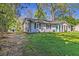 Attractive home featuring a well-kept lawn, charming details, and ample outdoor space at 8304 Ephesus Church Rd, Villa Rica, GA 30180
