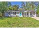 Charming single-story home with a well-manicured lawn and a bright blue front door at 8304 Ephesus Church Rd, Villa Rica, GA 30180