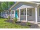 Inviting home exterior featuring a blue front door, fresh landscaping, and light gray siding at 8304 Ephesus Church Rd, Villa Rica, GA 30180