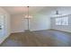 Open floor plan living room with wood-look flooring and lots of natural light from windows and doors at 8304 Ephesus Church Rd, Villa Rica, GA 30180