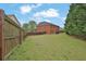 Large backyard with a wooden fence surrounding the home at 2384 Allsborough Way, Dacula, GA 30019