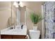 Powder room features a single sink vanity with a white sink and matching toilet and blue patterned shower at 2384 Allsborough Way, Dacula, GA 30019
