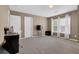 Bright, airy bedroom with neutral walls, carpet and minimalist furniture, including two TVs at 2384 Allsborough Way, Dacula, GA 30019