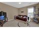 Bedroom has a cozy seating area, a window, and warm, neutral-colored walls at 2384 Allsborough Way, Dacula, GA 30019