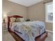 Cozy bedroom features a comfortable bed, a bedside table, and a window for natural light at 2384 Allsborough Way, Dacula, GA 30019
