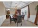 Formal dining room featuring a coffered ceiling, elegant chandelier, and wainscoting at 2384 Allsborough Way, Dacula, GA 30019