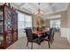 Elegant dining area with a chandelier, a decorative cabinet, and comfortable seating at 2384 Allsborough Way, Dacula, GA 30019