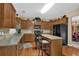 Well-lit kitchen with wooden cabinets and granite countertops at 2384 Allsborough Way, Dacula, GA 30019