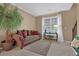 Cozy living room with a comfortable sofa, neutral decor, and a large window for natural light at 2384 Allsborough Way, Dacula, GA 30019