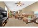Spacious living room with a plush brown sofa and a view into the kitchen at 2384 Allsborough Way, Dacula, GA 30019