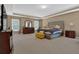 Spacious main bedroom with tray ceilings, a king-size bed, and ample natural light from the windows at 2384 Allsborough Way, Dacula, GA 30019