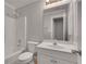 Bright bathroom featuring a tub-shower combo, white vanity, and large mirror at 3085 Woodbridge Ln, Canton, GA 30114