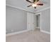 Bedroom with neutral carpeting, ceiling fan, and white trim, perfect for relaxation at 3085 Woodbridge Ln, Canton, GA 30114