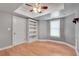 Bedroom with hardwood flooring, built-in shelving, and a window for natural light at 3085 Woodbridge Ln, Canton, GA 30114