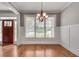 Bright dining room featuring hardwood floors, wainscoting, and a chandelier at 3085 Woodbridge Ln, Canton, GA 30114
